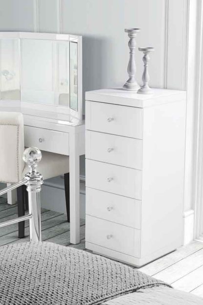 b39b8e87d444a2dff387eb68e5d29fc7704d6818f6986f4e726de255745d95a1.jpg An Image of Julianna White Glass Tallboy Chest with 5 drawers