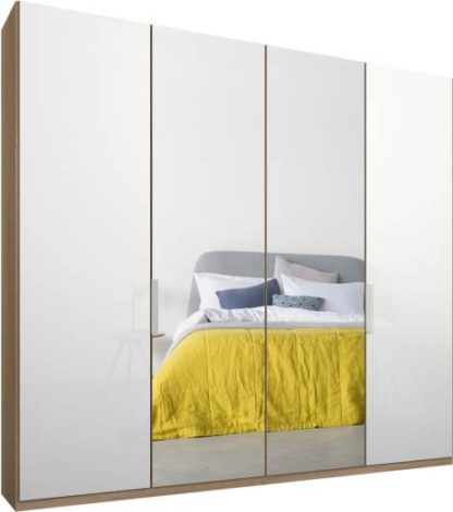 dd2d8971e66eecd7627b258b1ab9b926a47940294f7df743d12b29a11a0e8d4c.jpg An Image of Caren 4 door 200cm Hinged Wardrobe, Oak Frame, White Glass & Mirror Doors, Standard Interior