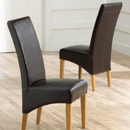 An Image of Choe Brown Bonded Leather Dining Chairs With Oak Legs In A Pair