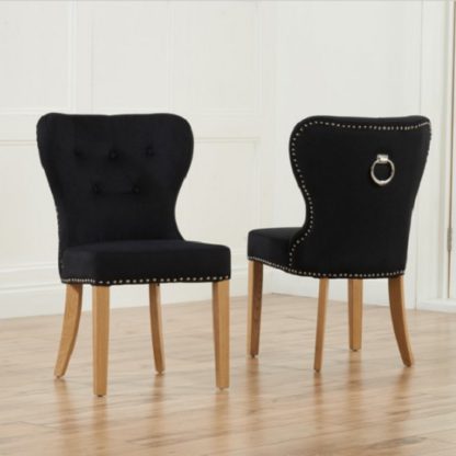 1d218c9e6ce7dea353ed931aae20d9e607bb19937a1c100ed3c08843db6b7bbc.jpg An Image of Wallace Dining Chair In Black Velvet With Oak Legs In A Pair