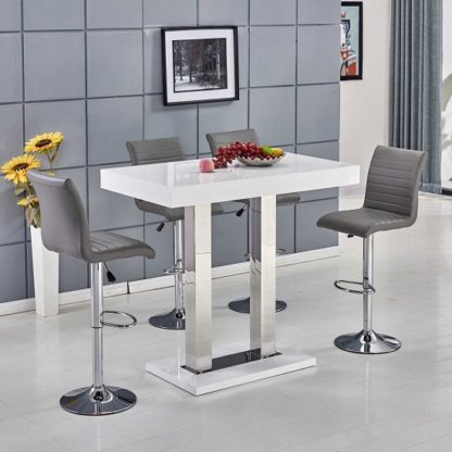 21b6f9e23c572d0b0703f2f75d923ef66fe4dee3df4a69bfb09cf8610d0835bd.jpg An Image of Caprice Bar Table In White Gloss With 4 Ripple Grey Bar Stools