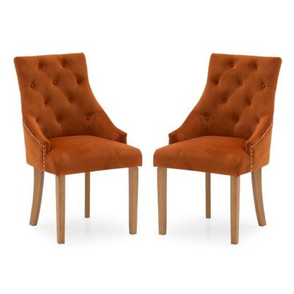 32a6bac886e0575856ca21d0976cd7530c97f09d8c4d4423049feff4d568590e.jpg An Image of Vanille Velvet Dining Chair In Pumpkin With Oak Legs In A Pair