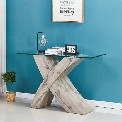 601328f78f49c182c224f3995aec0b8c8ec89ade4949f6e99477b495229ee5e8.jpg An Image of Xanti Glass X Base Console Table In Clear With Grey Oak Effect