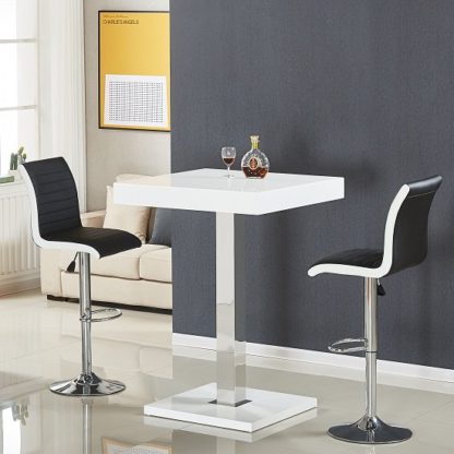 62d57ed3bbf1739433bf451c29a6e2310947a8470db6097e0f37864b4120cf7c.jpg An Image of Topaz Bar Table In White High Gloss With 2 Ritz Black Stools