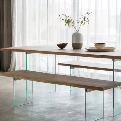 86b13213e3a7560ac9590a46c016e4c914ebe540cc75129ee54a6360d3bba225.jpg An Image of Ferndale Dining Bench In Oak With Glass Stand
