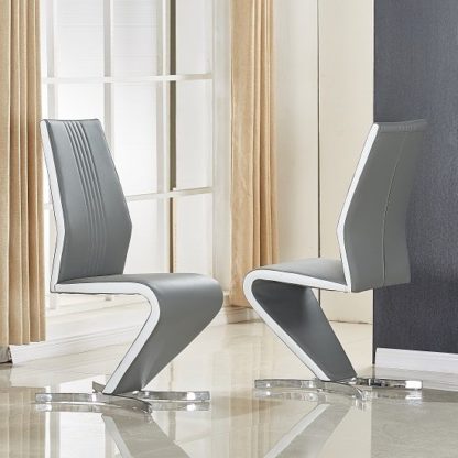 9e218d0df7b22421b55b9273d86afe64df103117ac8de31a1256aff9d938f227.jpg An Image of Gia Dining Chair In Grey And White Faux Leather In A Pair