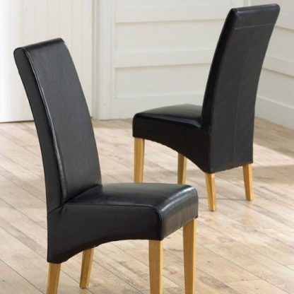 An Image of Choe Black Bonded Leather Dining Chairs With Oak Legs In A Pair