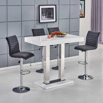 bfe311d915a9069abe19364c8c24a891fecf11f065d1732f367728acdfeb8995.jpg An Image of Caprice Bar Table In White Gloss With 4 Ripple Black Bar Stools