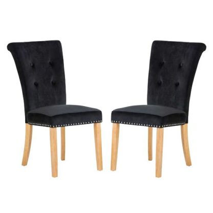 An Image of Wodan Velvet Dining Chair In Black With Oak Legs In A Pair