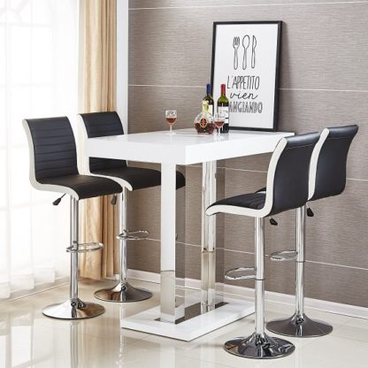 d7501f6032b3f880f698a3cc90fb6a3b749587583c3a353c59358d86b8ac74e3.jpg An Image of Caprice Bar Table In White High Gloss With 4 Ritz Black Stools