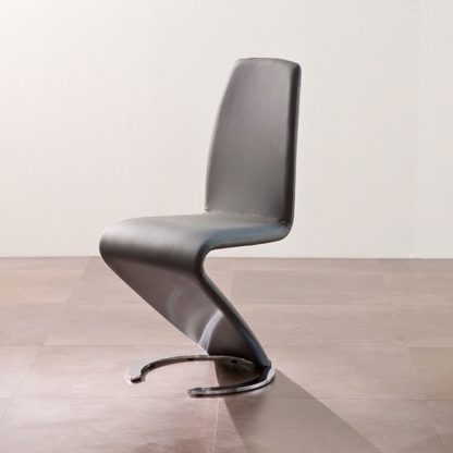 db0fa780be8f11d1f3e7cc5772d8454a3973f5805f6aad3a6036f7d32961ea65.jpg An Image of Swing II Metal Swinging Grey Real Leather Dining Chair