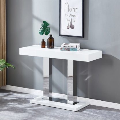 efef7ece1f6eea56cdca5e98fd3fd599e7fb138d55c3cb6f0beb9a5f18400871.jpg An Image of Candice Console Table In White Gloss With Stainless Steel Legs