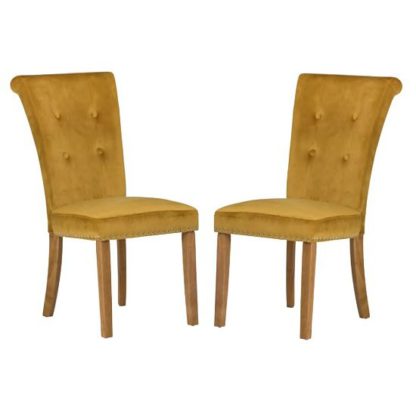 f36d4a986e4fabb0956a38380089f3f2d5f2b1ee93b7fedb324c15e1af6728a7.jpg An Image of Wodan Velvet Dining Chair In Mustard With Oak Legs In A Pair