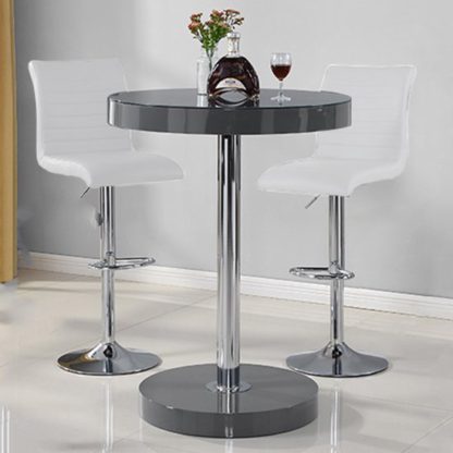 fd1a09516467ad6e4d0d0e0de179c2982f023c59827df0f27d93e0c7580a1f44.jpg An Image of Havana Bar Table In Grey With 2 Ripple White Bar Stools