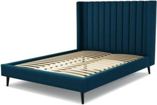 An Image of Custom MADE Cory King size Bed, Navy Wool with Walnut Stained Black Stained Oak Legs