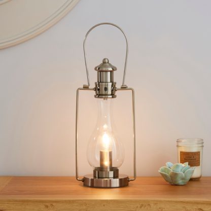 36ad2c6c32508622207a1acf8aa08f7753fe7bd8a12f1c336ecf0a5a4f17df54-1.jpg An Image of Horse Lantern Satin Nickel Table Lamp Silver