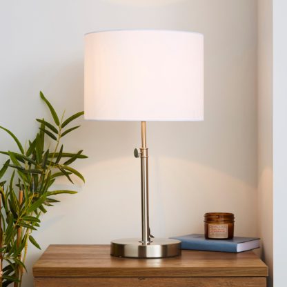 929473d9c7e6b2ef808e7f83f5d4b01b7d51c3e6f7c33d8d0a8a23c71d8fd2ff-1.jpg An Image of Hemming Adjustable Height Satin Nickel Table Lamp Satin Nickel