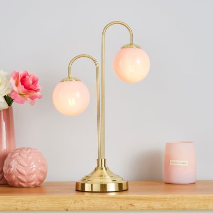 4f0bf34d1666f32eb1ca52f850bea2c5b428b497db69ce54a80bc2fc4582fea6.jpg An Image of Gigi Pink Table Lamp Pink