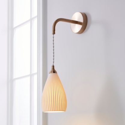 7b552e67e6de7a4cfb64743d6b5564df5dedb9a61b97d2762fbe15c5cf8fe540.jpg An Image of Dorma Purity Ribbed Porcelain Wall Light White