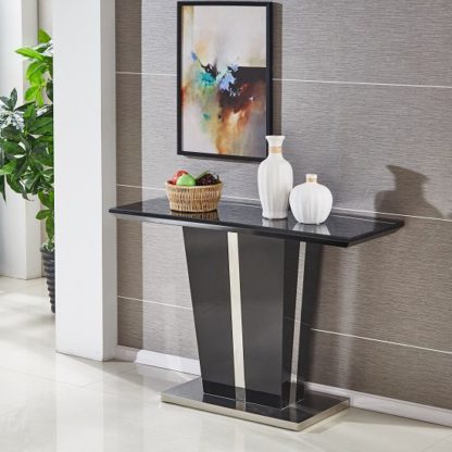 b8ab4082e15ab7268389a172789ca6032db250575699ce7589f36b4faa86020d.jpg An Image of Memphis Console Table In Black High Gloss With Glass Top