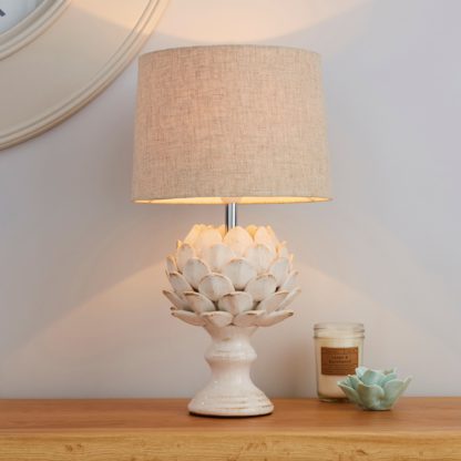 eaec4a48890920a0f448011ff73fbbc4912c7bf373e536bbed9ded279a58602e.jpg An Image of Dorma Brimstage Cream Artichoke and Linen Shade Table Lamp Cream