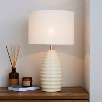 eb6451ab8839fa90358a78e88a8fddb978a78629fd100e73bfe9982870889a92.jpg An Image of Norden Ribbed Ceramic Ivory Table Lamp White