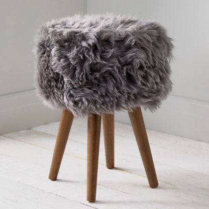 407c65b1f24b86725643cf94e0fd926d69bf6a79a6700b42767b2ec0f448c255.jpg An Image of Bovril Sheepskin Stool In Grey With Solid Oak Legs