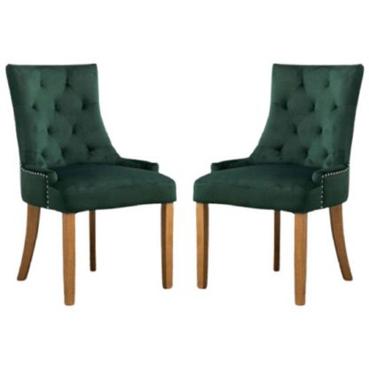 56f01ad418d029d3c7df9d3ac70fd12c655ec9267c756761309fcd713a118f36.jpg An Image of Lauren Dark Green Velvet Dining Chairs With Oak Legs In A Pair