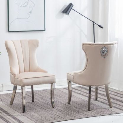 b7203ba5a2f8020f521e3a30ba03bf7840df173e3d37f49e6d87229bffe0f723.jpg An Image of Monten Lion Knocker Cream Velvet Dining Chairs In Pair