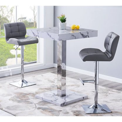 c8191193e4ddad518bfca3573e30d64efacf429a885c4d015ba2638223a827ba.jpg An Image of Topaz Gloss Bar Table In Diva Marble Effect With 2 Candid Grey Bar Stools