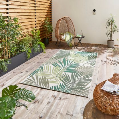 e0339819602667d132991299fb65db84c94c033654bea2c212112f6db431a1a2.jpg An Image of Miami Leaf Print Indoor Outdoor Rug Dark Green