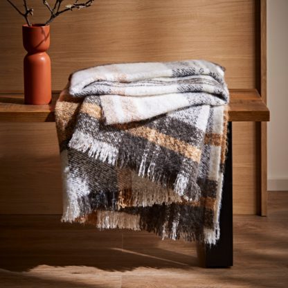 9d0c6d2c4e0a14f48fabd8d8f681826f38cbe6c512ce1310a6392a5452473d6a.jpg An Image of Boucle Check Knit Taupe Throw Taupe