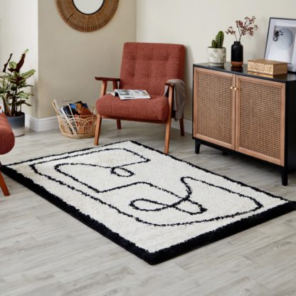 4b49657bd8aedbad53ac42115167f48006c3081d4bf7b8a510e7f8305c78bd6f.jpg An Image of Berber Line Rug Black and white