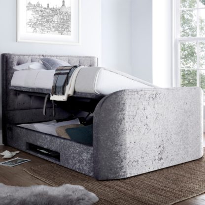 edd7c6d679a2e8bbef4e3f9a08110ed5f2fcb9f568424cd04ded89b8aaa02448-1.jpg An Image of Lyon Silver Velvet Fabric Ottoman Media Electric TV Bed Frame - 4ft6 Double