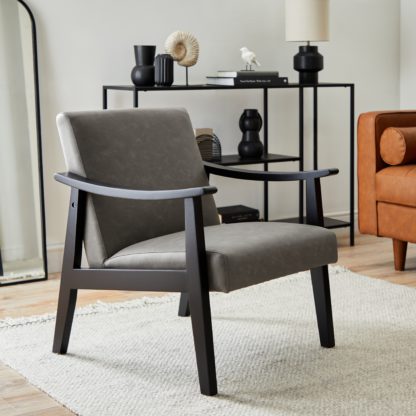 aa28a4b06a0872d4f10bf1991ce21406cec35bb05da81447de32fc2111dced14.jpg An Image of Merrick Distressed Faux Leather Armchair Grey