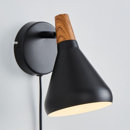 4e0257ce723e678fc9a5db74be0cdae50cecb2c473a401e6528ab235d95de07b.jpg An Image of Elements Wolston Plug in Wall Light Black