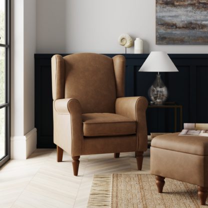 aae3c7cc99e8e2c1bf3ac40952c71b779bae8693a0dd2de1f5de4895b44405f9.jpg An Image of Oswald Mocha Distressed Faux Leather Armchair Brown