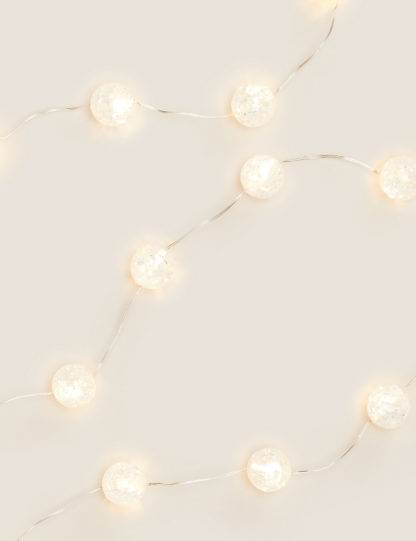 10fd2834384d84a668768068de690d86b51ae6a040c578d1469707864df7cc47.jpg An Image of M&S 20 Frosted Ball String Lights