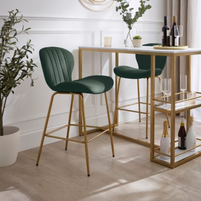 e5bf9767306c6844779f8e720ae9f4b18e9016f648cd357d35f21ca08aebaea7.jpg An Image of Lila Counter Height Bar Stool, Velvet Velvet Bottle Green