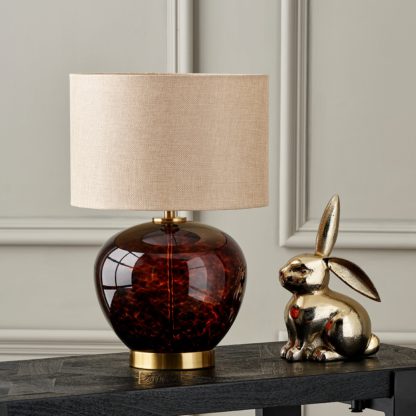 4ee07cbb96be91ce5e139ec81091ab06087207730224742473b4bf0541ca5476.jpg An Image of Lucien Tortoiseshell Glass Table Lamp Taupe