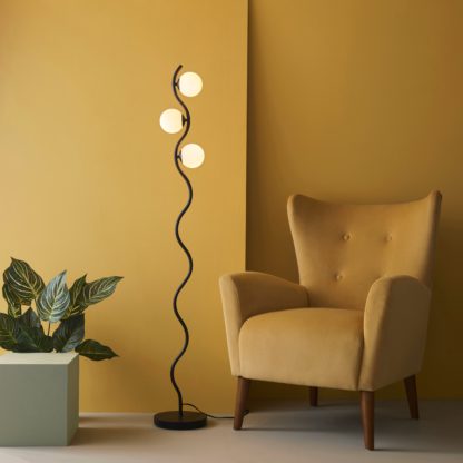 1f9684166b9db0a840a8ddb1babdd794b02b5906ab1affc0724bedab3d1d312a.jpg An Image of Wiggle 3 Light Metal Floor Lamp Black