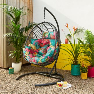 An Image of Black Egg Chair with Tropical Cushion Green