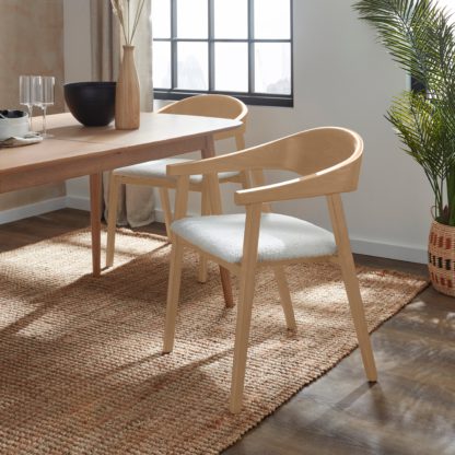 ef72093c9a68592c98a8311fdb562da1bfd773944a27634632213f40c5b29503.jpg An Image of Oskar Dining Chair, Boucle Black Stained Wood