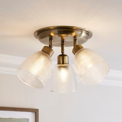bf85f046f42502c29386a276c86be5c49bea65e02d2350734976fab126e49aff.jpg An Image of Kibworth Ribbed 3 Light Adjustable Spotlight Brass