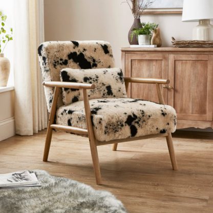 0d9fa3d5f3083aae2ba54e020852d4d4505c10d8cca5b98e80c10fd0a0bcbcd4.jpg An Image of Alpine Cow Print Faux Fur Spindle Accent Chair