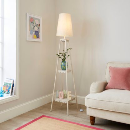 55cf5f063cfe561deb92818138319a4d61619ebadd2e2b5777072c9a15e7e8a9.jpg An Image of Remi Shelved Tripod Floor Lamp