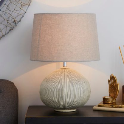 7eb1fd0aec511f416d71c6fb57940a3c16fe71175645dd703207134a06cb3757.jpg An Image of Dahlia Scratched Resin Grey Table Lamp