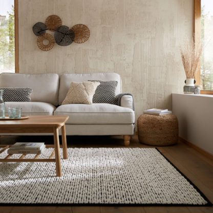 b0d4c7652c21ee8fdd6768dab304daf24f2462a88f8e293ed7d4591ef87d322c.jpg An Image of Braided Wool Rug