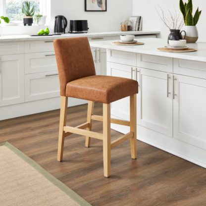 e11c8a3d86a1d168775f8e2d1791cf8369c142d351d06e9d67c82c792243accc.jpg An Image of Oakley Counter Height Bar Stool, Tan Faux Leather