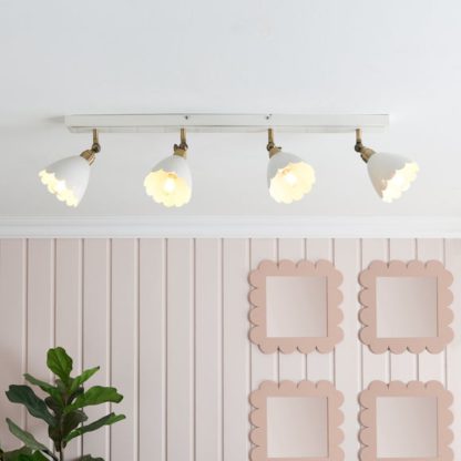 e6e7e1ad4bee4347dd99874f22a1d679259080d8af8275a63da68a62456a4731.jpg An Image of Remi Scalloped 4 Light Adjustable Spotlight Bar